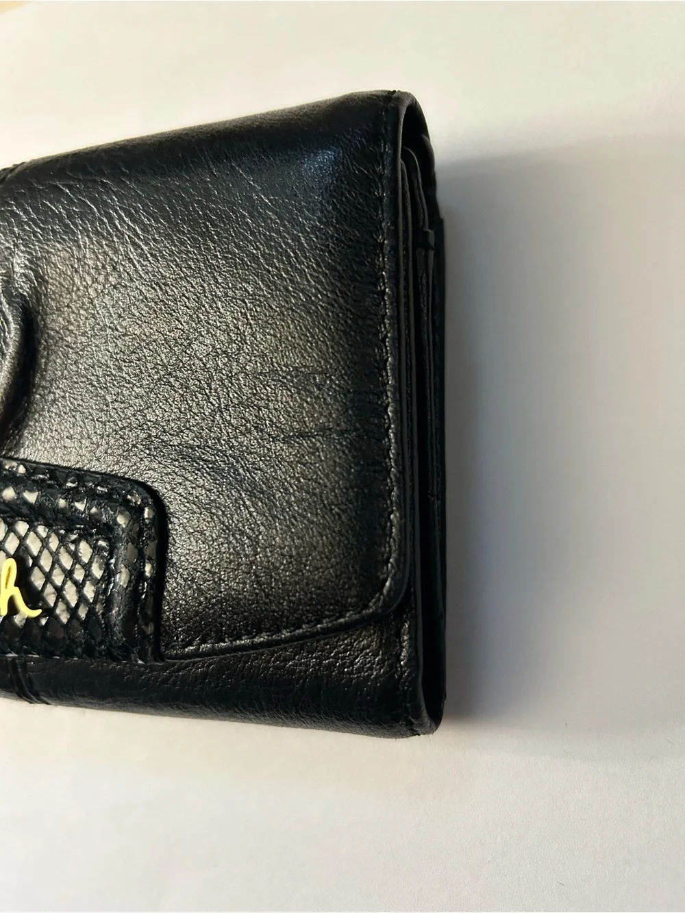 Coach Women’s Black Tri-Fold Wallet with Gold Script Logo